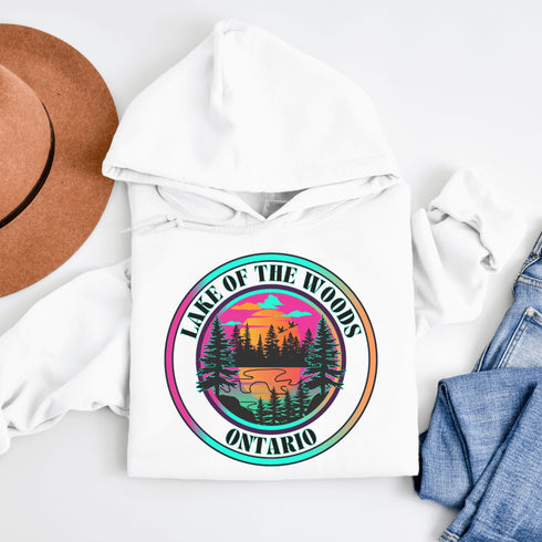 Featuring a stunning lake scene with a vibrant sunset, this hoodie captures the beauty of Lake of the Woods in Ontario, where tranquil waters meet the warm glow of a setting sun.